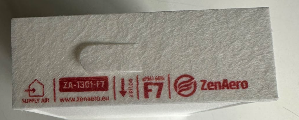 Close-up of a ZenAero F7 supply-air filter label with airflow arrow